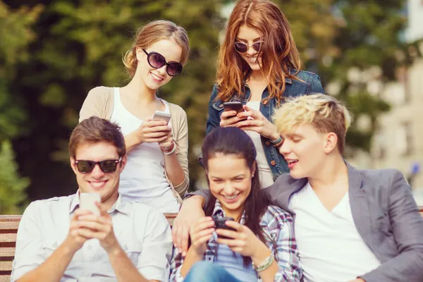 Students looking at smartphones and tablet pc