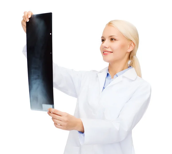 Smiling female doctor looking at x-ray