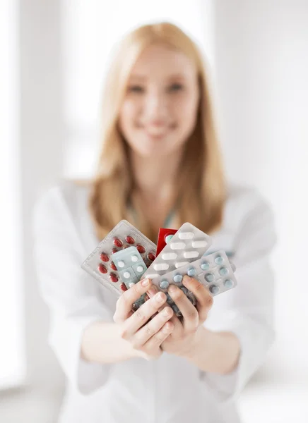 Female doctor with packs of pills