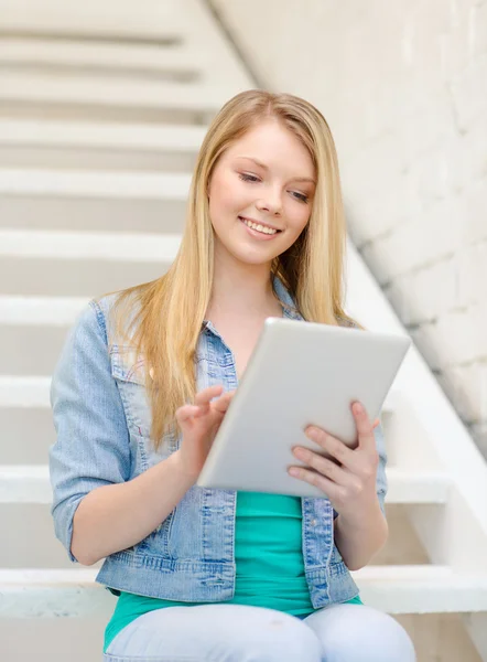 Smiling female student with tablet pc computer