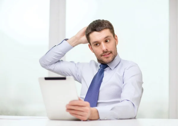 Stressed businessman with tablet pc and documents