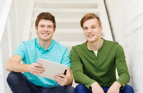 Smiling male students with tablet pc computer