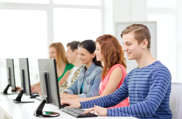 Male student with classmates in computer class