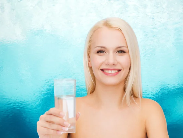 Young smiling woman with glass of water