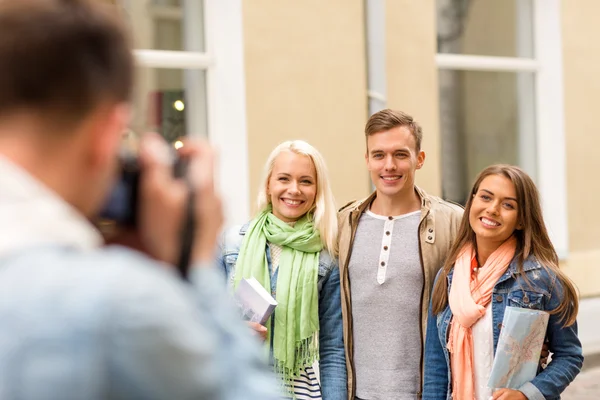 Group of smiling friends taking photo outdoors