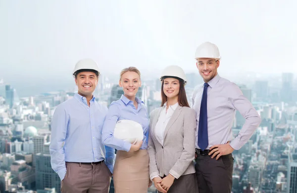 Group of smiling businessmen in white helmets