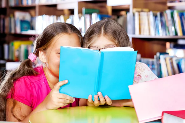 Two girls reading a book