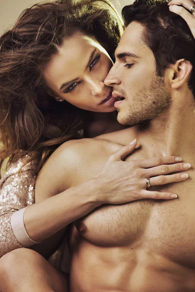 Sensual woman touching her boyfriend's perfect body