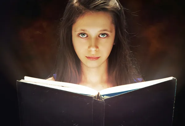Young girl reading an old book