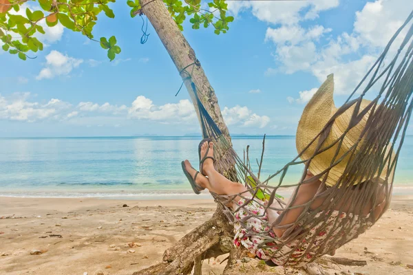 Woman hammock sleep on the beach in thailand.