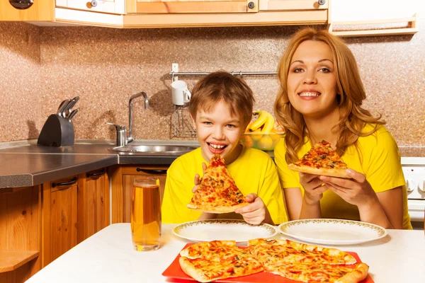 Boy and his mother ready to eat pizza together