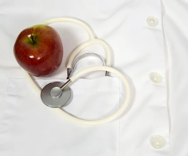 Apple and stethoscope on a lab coat