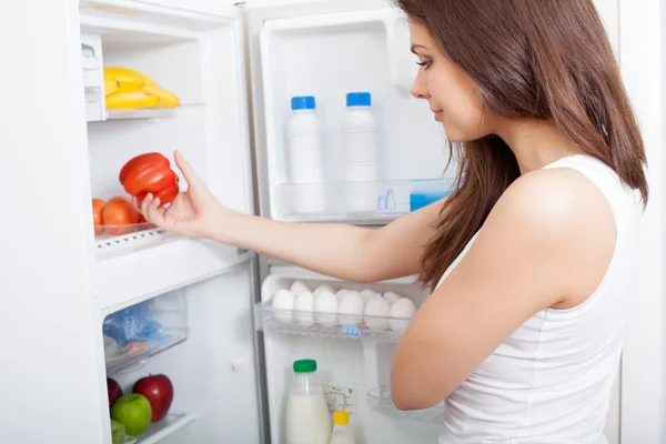 Woman searching in her fridge