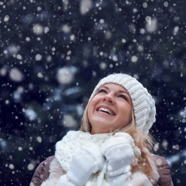 Happy woman under snowfall