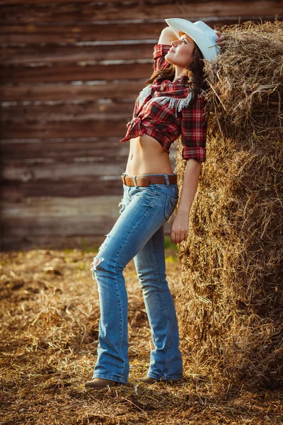 Cowgirl model posing on farm