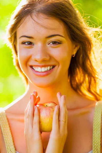 Closeup girl portrait holding apple
