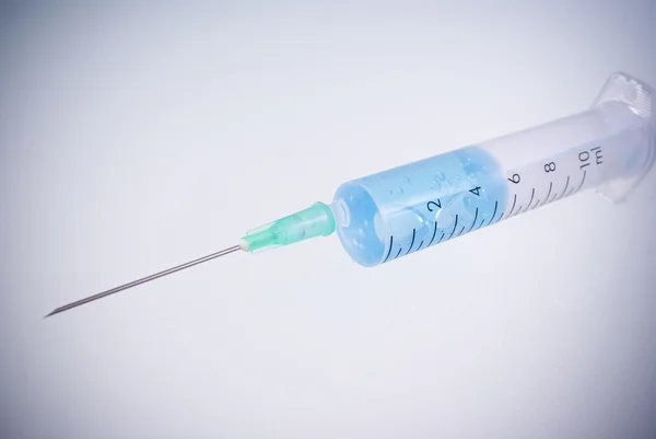 Photo of Medical Syringe on grey background