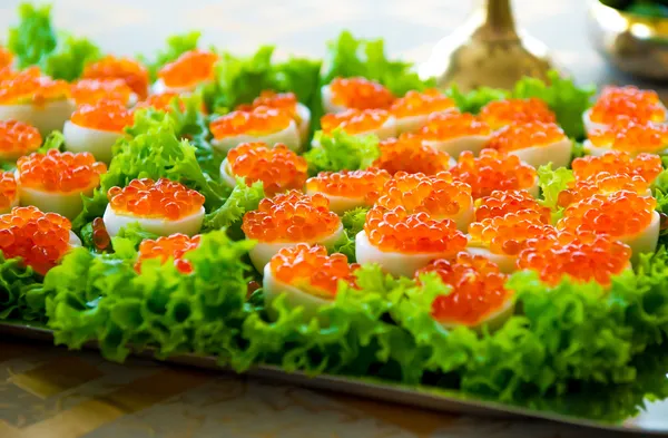 Stuffed eggs with red caviar