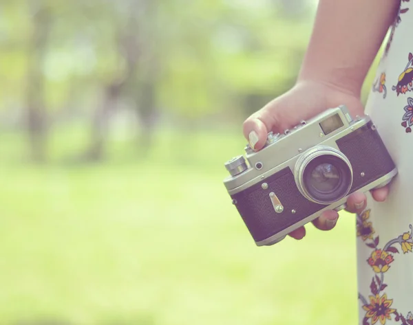 Close up of woman hand holding retro camera