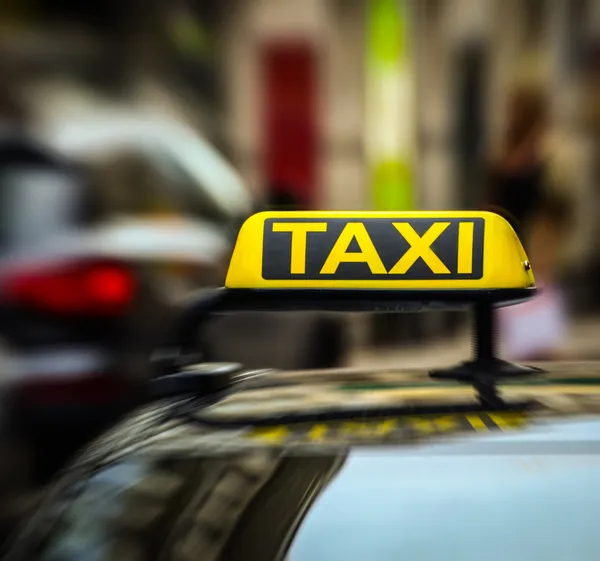 Taxi sign on car in motion blur