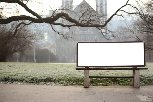 Blank billboard on bench at city park