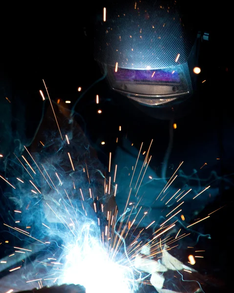 Welder in action with bright sparks.