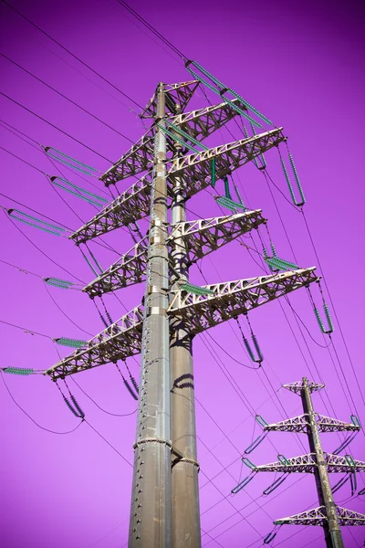 High-voltage tower on a background of purple sky