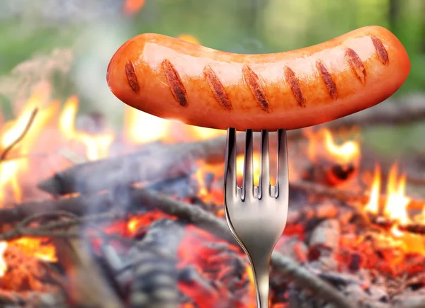 Sausage on a fork.