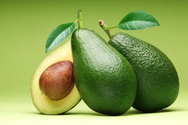 Avocado isolated on a green.