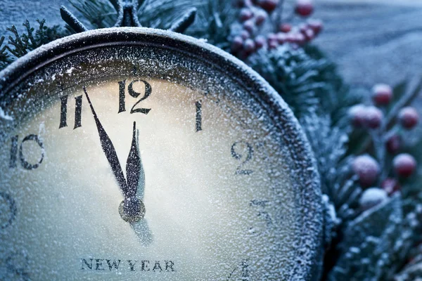 New Year clock powdered with snow.