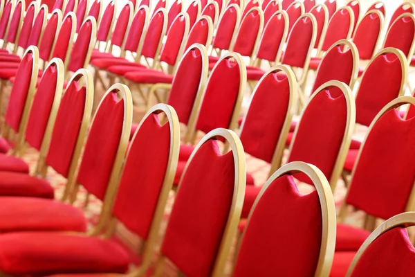 Ranges of empty red chairs.