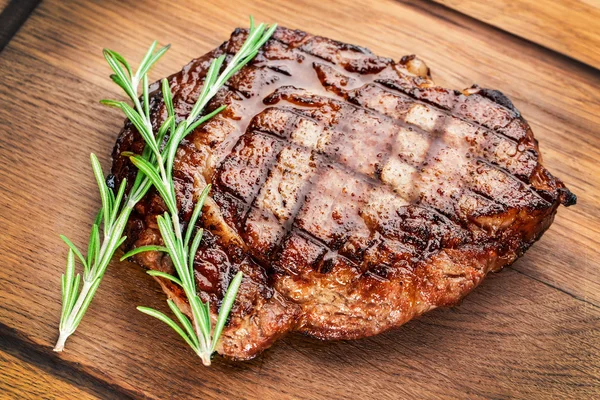 Beef steak on a wooden table.