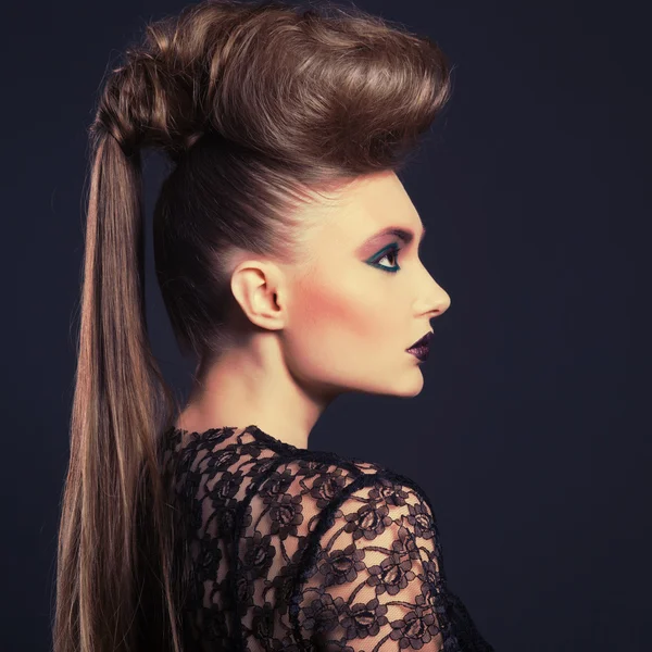 Fashion beauty portrait of sexy woman with creative hairstyle and make-up