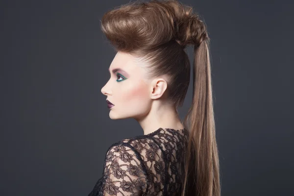 Fashion beauty portrait of sexy woman with creative hairstyle and make-up