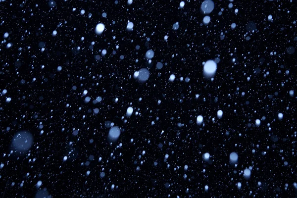 Falling snow on a dark background