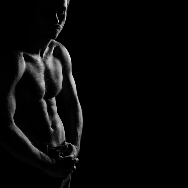 Black and white image of shirtless muscular man