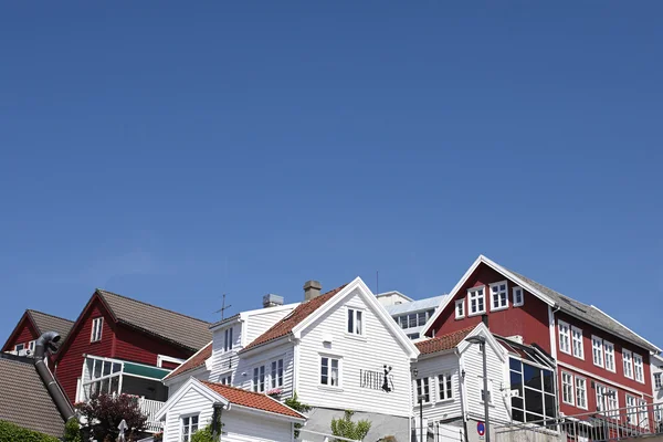 Typical norwegian red and white wooden houses with roof background, Haugesund