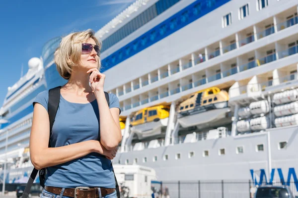 Woman in front of cruise liner