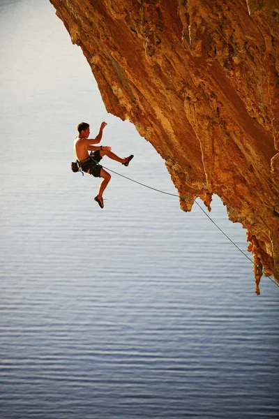Rock climber falling of a cliff while lead climbing