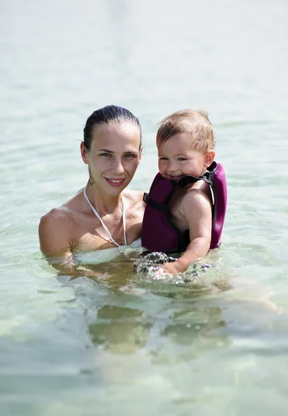 Yang and beautiful mother teach her baby son how to swim
