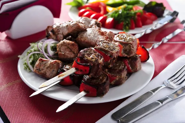 Plate of shish kebab cooked on skewers