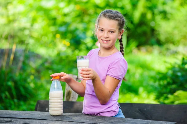 Yang pretty European girl posing with glass of milk