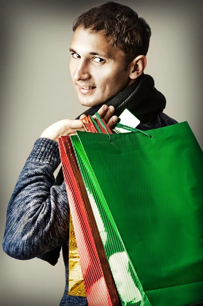 Fashion man holding shopping bags
