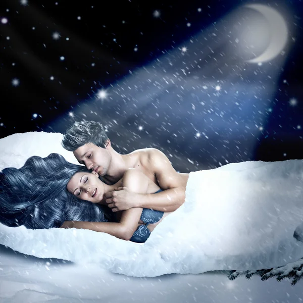 Loving fairy couple in a bed of snow