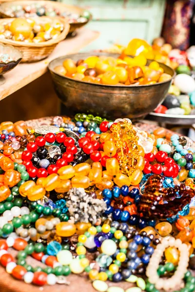 Colorful gemstones on sale at a flea market in Jerusalem, Israel. Multicolored background.