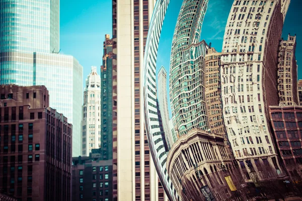 CHICAGO, IL - APRIL 2: Cloud Gate and Chicago skyline on April 2, 2014 in Chicago, Illinois. Cloud Gate is the artwork of Anish Kapoor as the famous landmark of Chicago in Millennium Park.