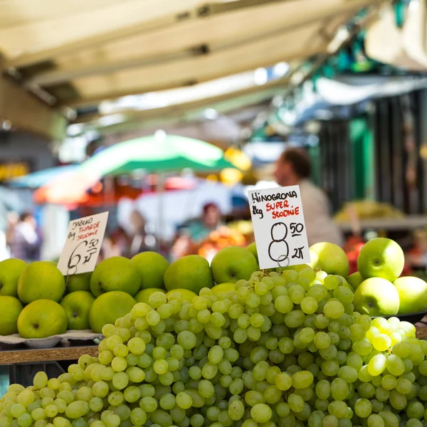 Grapes for sale in a basket on a open air market stall in Poland.