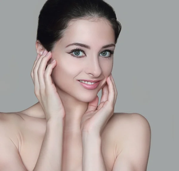 Beauty woman face with two hands at healthy skin isolated. Close