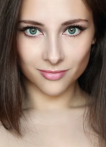 Closeup woman face with beautiful makeup looking sexy. Portrait