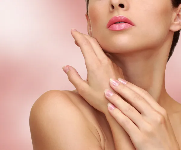 Beauty woman hands with health skin on pink background